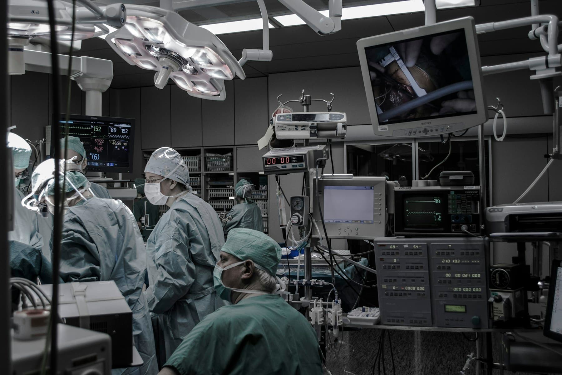 Surgical team performing robotic urologic surgery in an operating room